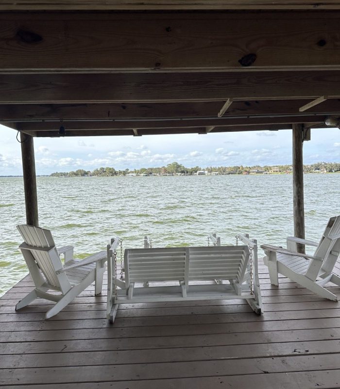 Photo of Dock and Seating Area with a Swing Loveseat, Swing Table/Bench, and Two Lounge Chairs